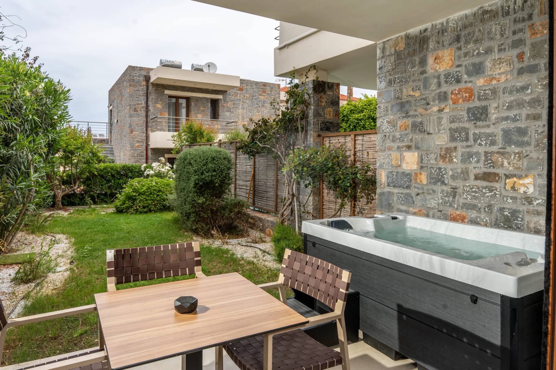 Outdoor hot tub in the private garden of a one bedroom suite