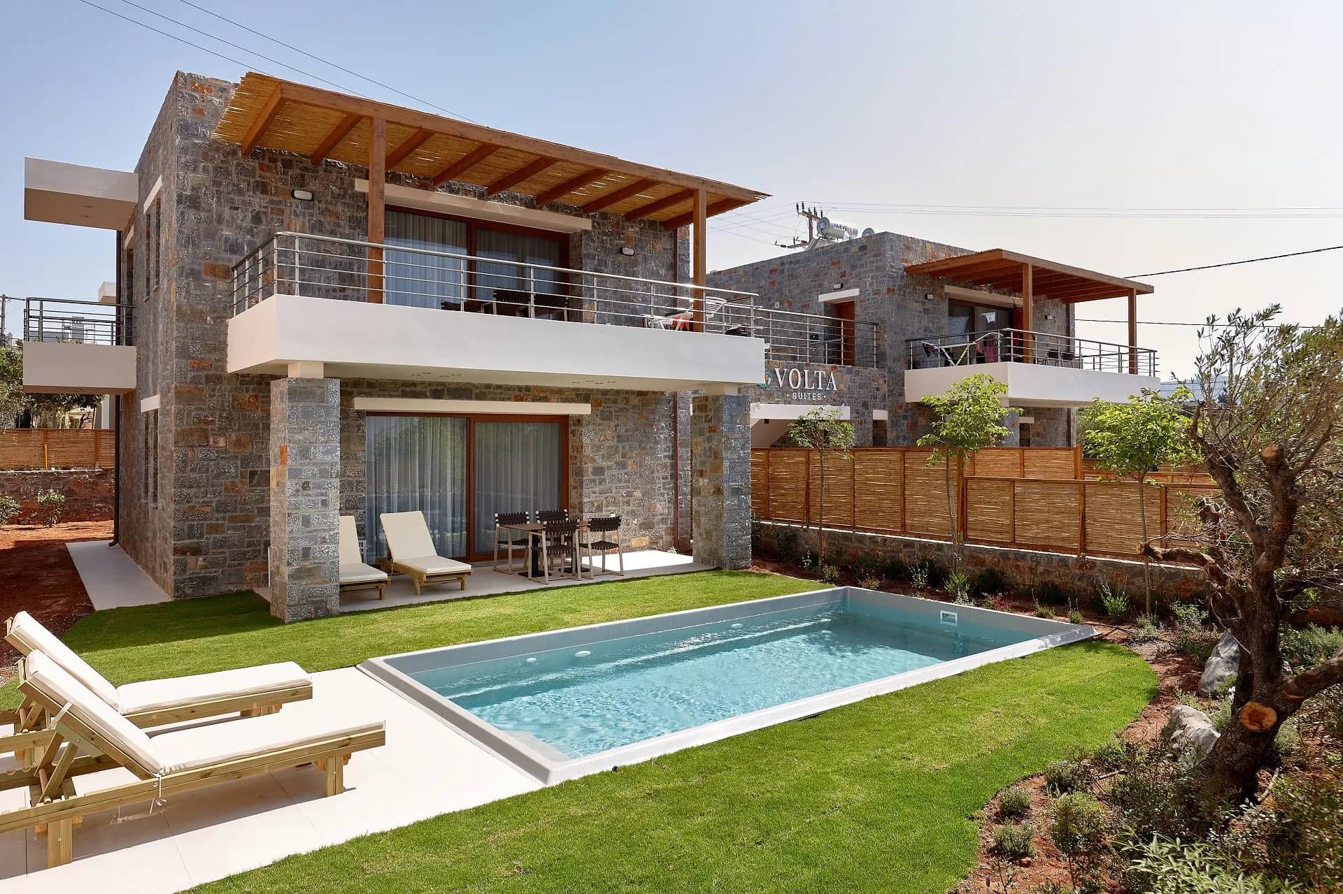 The four bedroom villa of Volta Suites and Villas with its private pool and stone facade in Kato Gouves, Crete