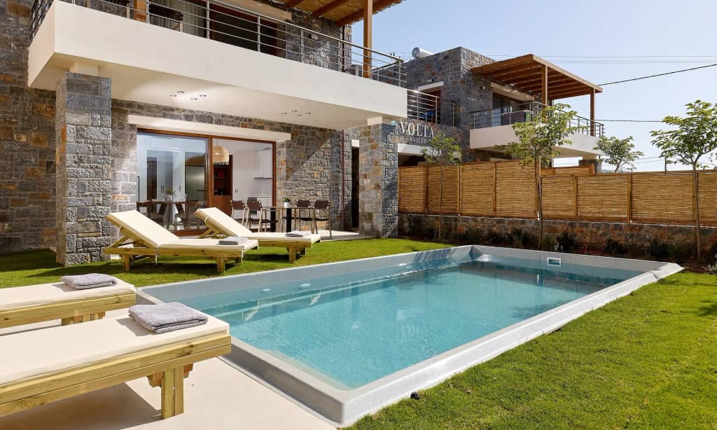 The swimming pool of Volta Suites and Villas surrounded by the garden