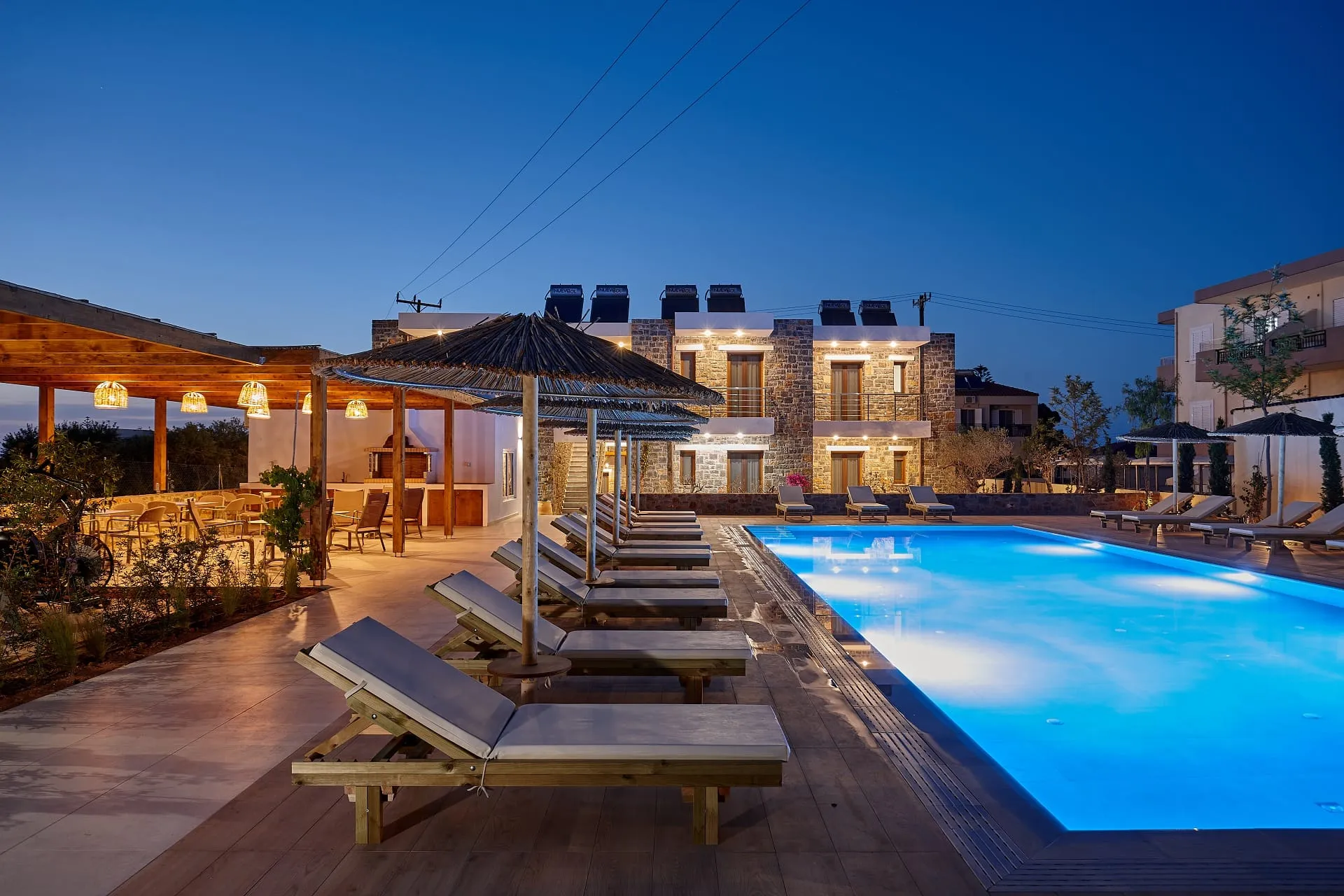 Evening view of the pool area of Volta Suites and Villas